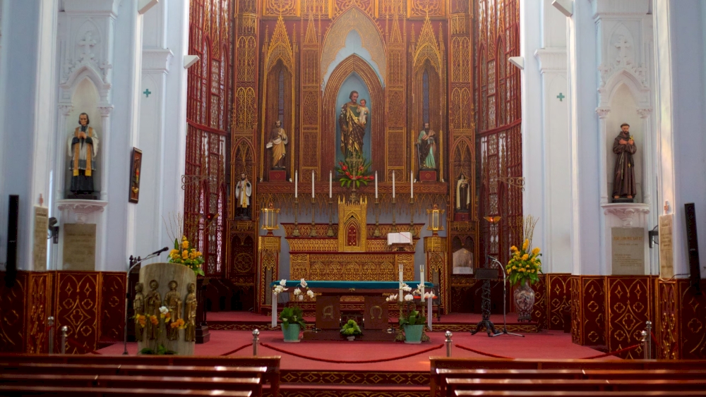The large altar is elaborately decorated and the statues of saints are intricately carved